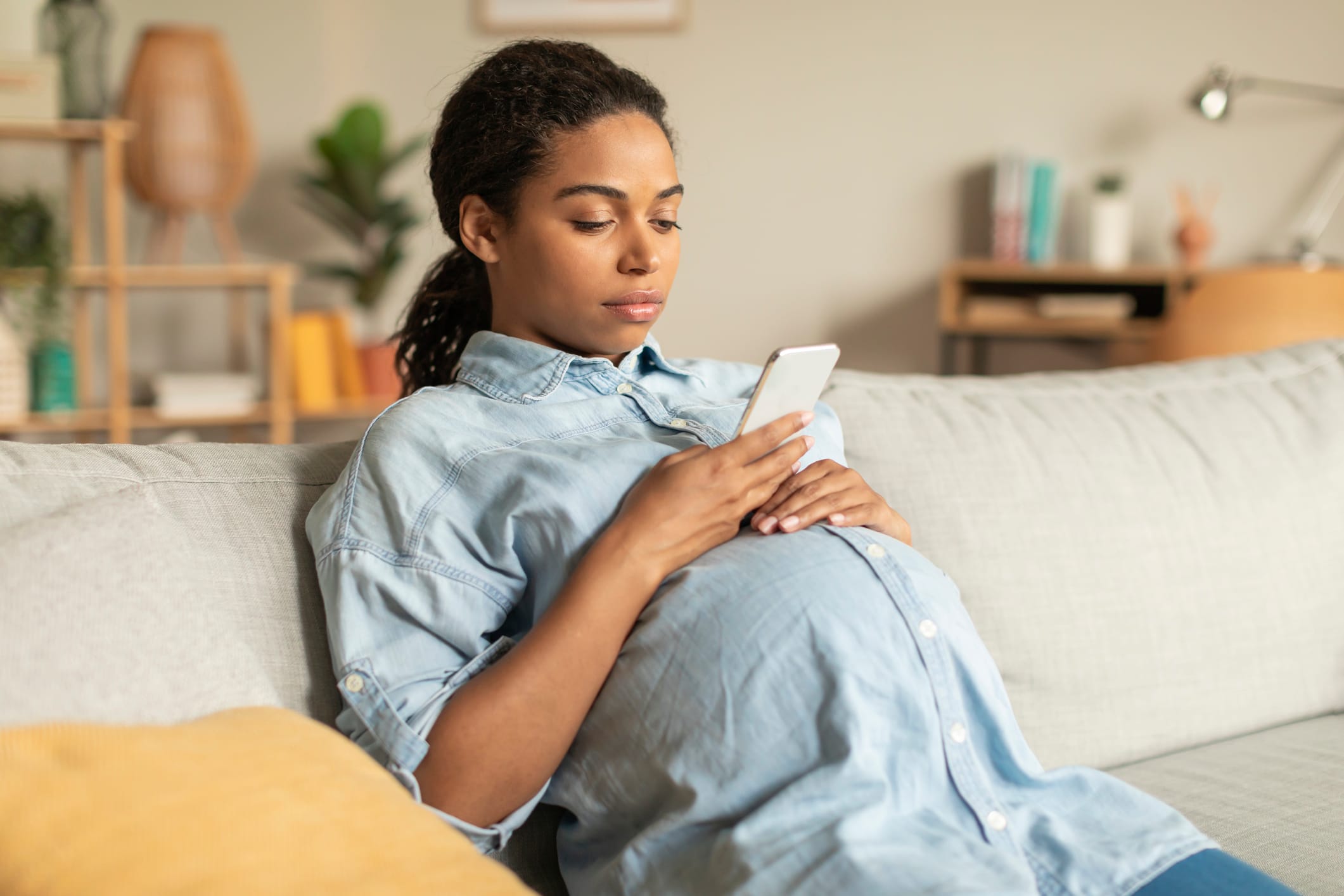 Black pregnant woman, reclining, quiet and calm